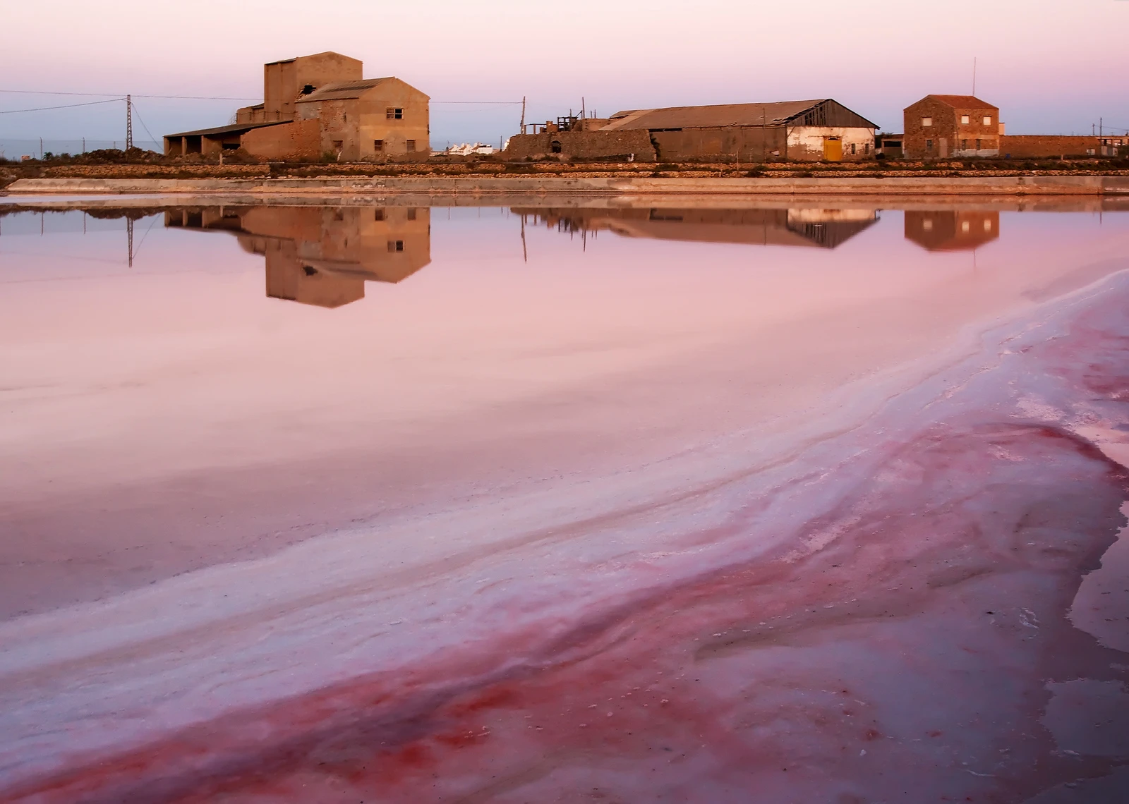 Salt pans whose brine is coloured pink by salt-loving microbes